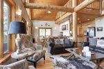 In  The Snow Lodge living room with log beams. 